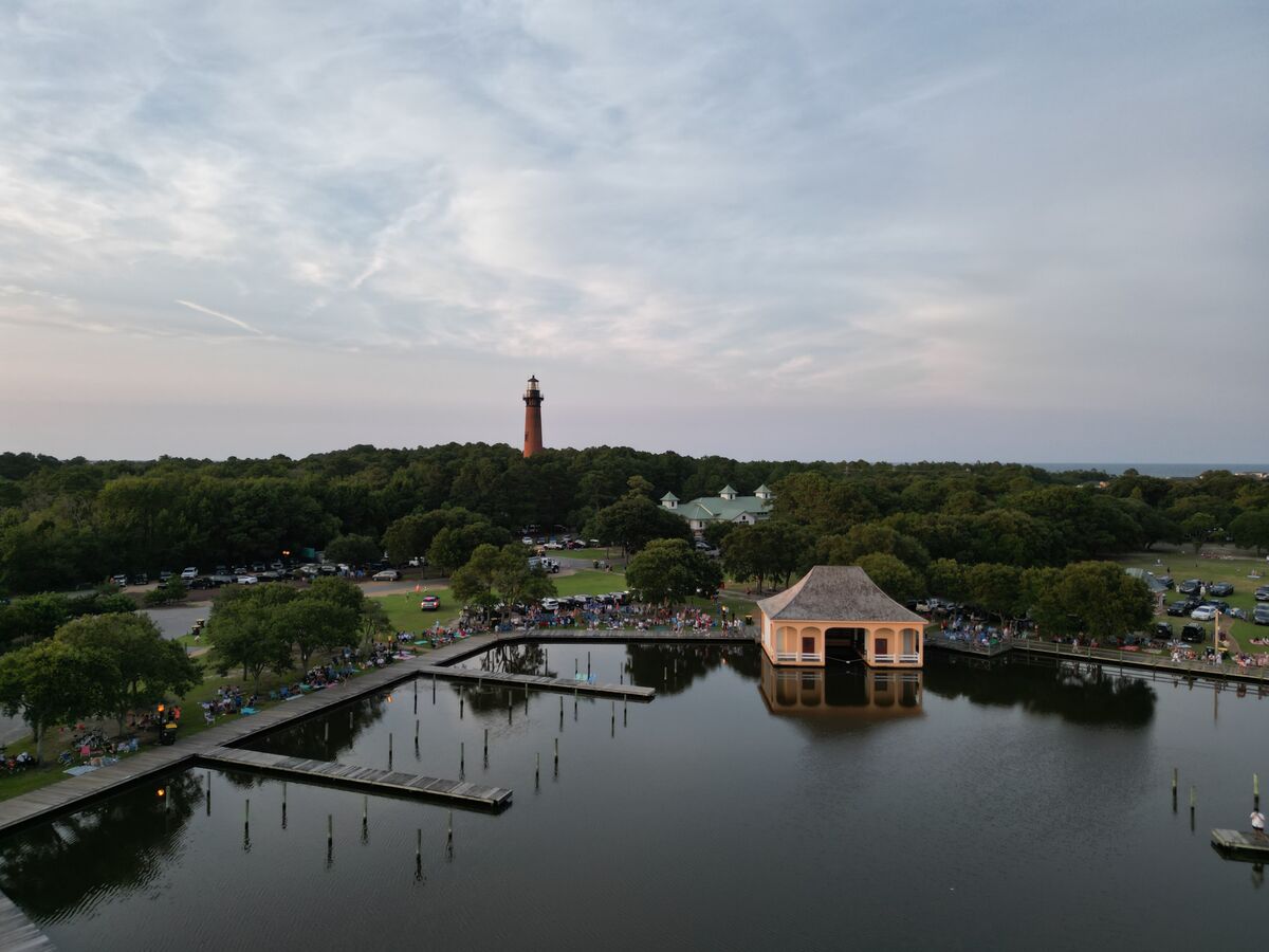 Aerial view of a coastal lighthouse at golden hour
