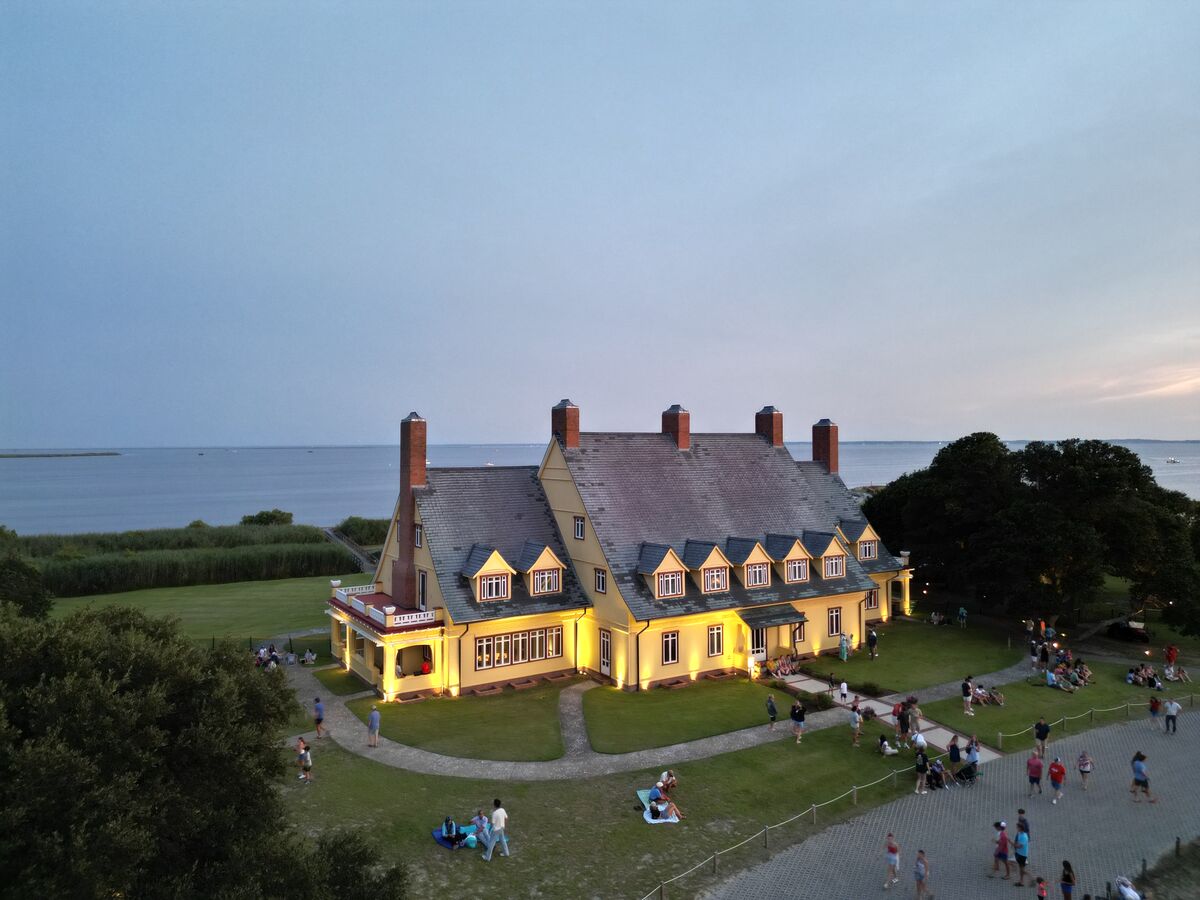 Aerial view of a landmark mansion illuminated at dusk