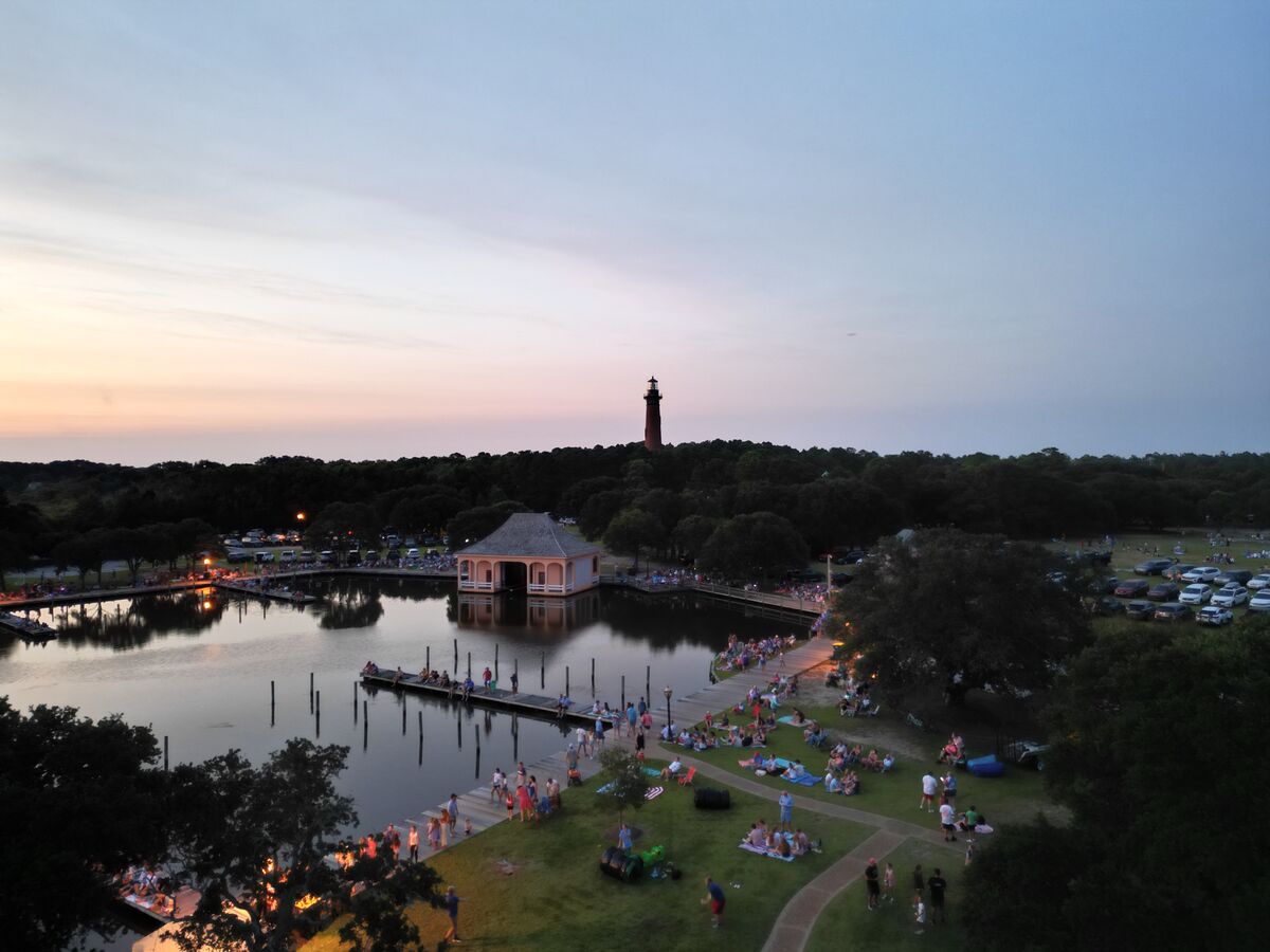 Aerial view of a landmark lighthouse area with boathouse at twilight